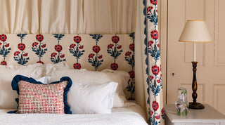 Four poster bed in a Georgian double bedroom dressed with Molly Mahon's Dianthus Indigo Iron hand block printed design from valance to headboard and curtains finished with a cushion in Seed Iron