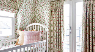 Molly Mahon wallpaper strawberry grass matched with strawberry design fabric curtains in an attic room designed for a young kids room
