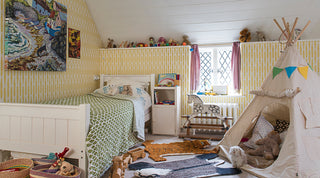 molly mahon fern wallpaper in a child's bedroom with tipi tent, toys and soft cuddly teddy bears in a sussex eves room with a small narrow window