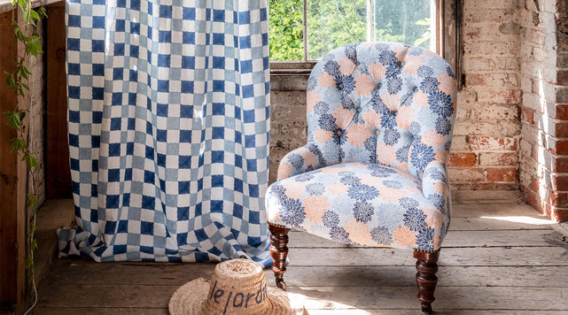 molly mahon bloom collection curtain in chequer blues and armchair upholstered in dahlia indigo peach