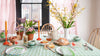 Easter with Molly Mahon celebrating around the kitchen table with Trellis table cloth and napkins decorated with spring blooming flowers. Delightful!
