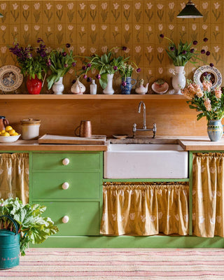 Molly Mahon Botanica tulip wallpaper and fabric in olive gold styled in an english country, farm kitchen.
