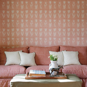 Pink Tulip wallpaper. Decorative cushions in colourful botanical prints styled on a country house sofa