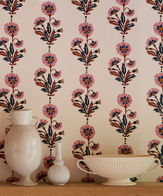 Closeup image of Molly Mahonos new Dianthus wallpaper in her rust rose colourway and three vases standing on a shelf mounted to the wall.