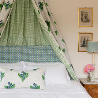 Double bed with head valance in Molly Mahon's Primrose hand block printed fabric with a head board in matching colours Trellis design finished off with a cushion in Primrose producing a beautiful spring like feel