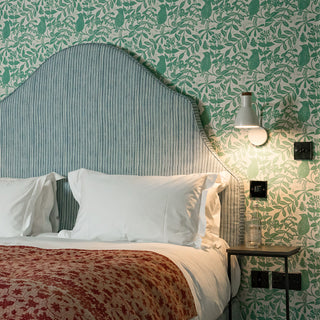 molly mahon wallpaper birds and bees design matched with stripe blue headboard at the swan