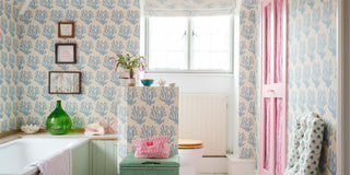 bathroom decorated in molly mahon wallpaper coral blue beautifully light with a haze of pink from the hand block printed fabric and greens from a soft upholster chair in berry grass sky fabric