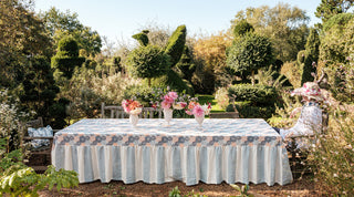 molly mahon's hand block printed fabric Dahlia and wide stripe in blue covering a garden table at Molesworth at the end of the dahlia season
