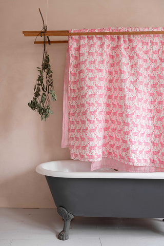molly mahon's hand block printed handmade quilt hanging above a bath in marwari horse design by molly mahon